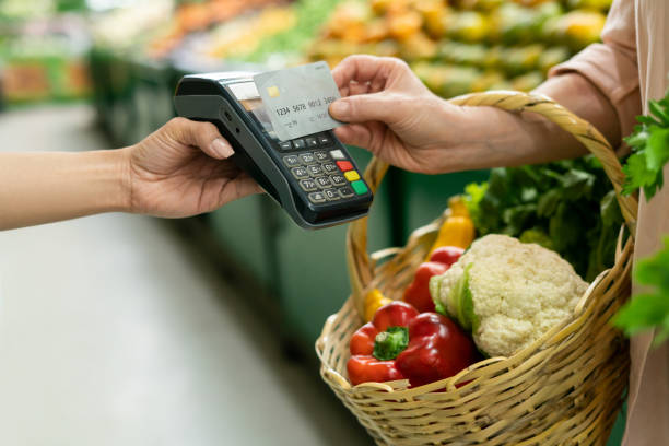 istock Customer making a contactless payment at the greengrocer's shop 1704180312