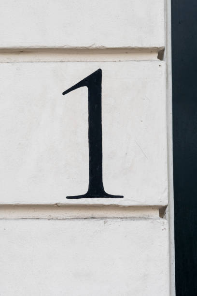 Number one door number hand painted in black on white wall