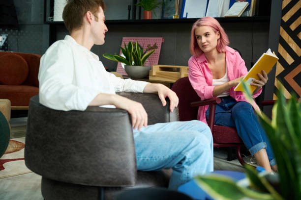 istock Young couple is sitting in soft armchairs in design studio 1704208128
