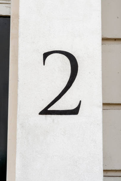 istock Number two door number hand painted in black on white wall 1704208131