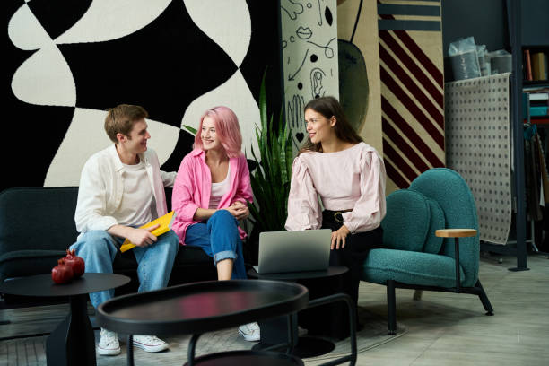 istock Three people are sitting in relaxation area and chatting nicely 1704208710