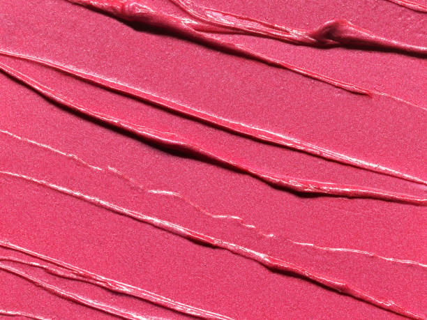 istock Pink lipstick shimmering texture, full frame texture background. Cosmetic product swatch 1704214371
