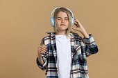 Teen girl in headphones looking enjoyed while listening to music