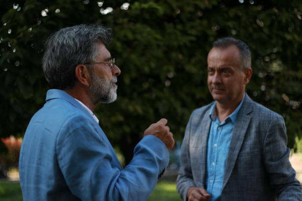 istock Two serious senior businessmen talking 1704240957