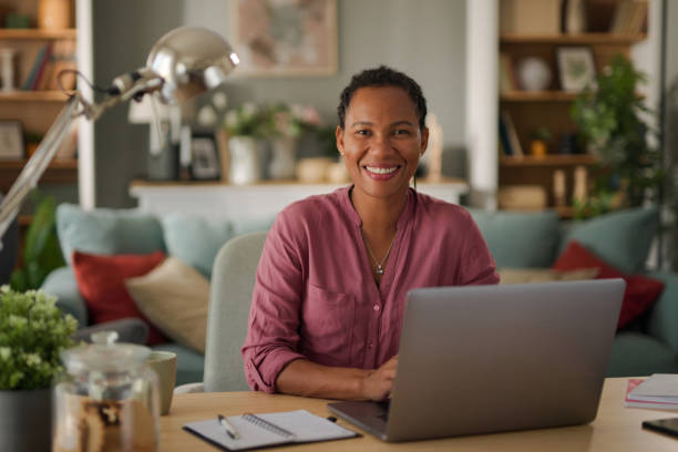 istock Smiling businesswoman using a laptop in her home office 1704244394