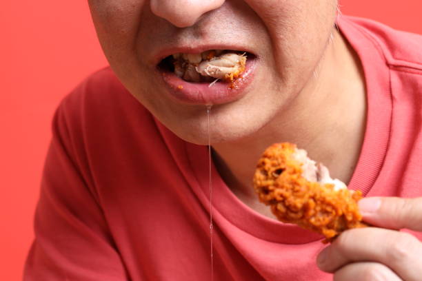 istock Man Eating Food 1704248772
