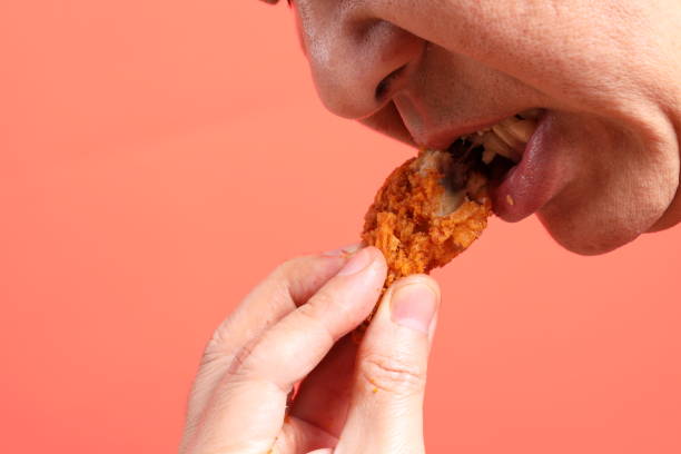 istock Man Eating Food 1704248804