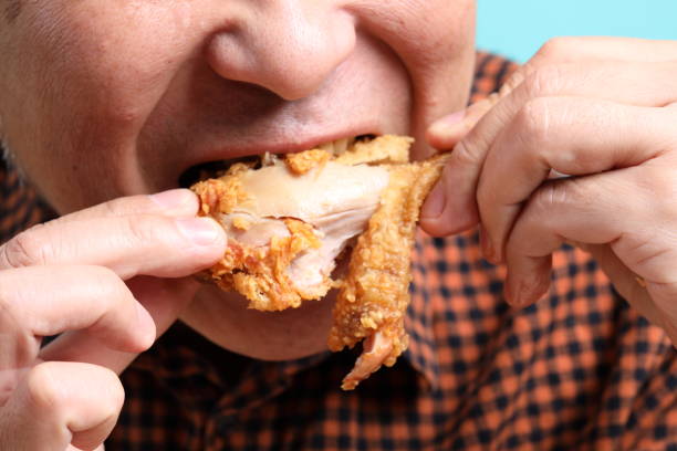 istock Man Eating Food 1704248827