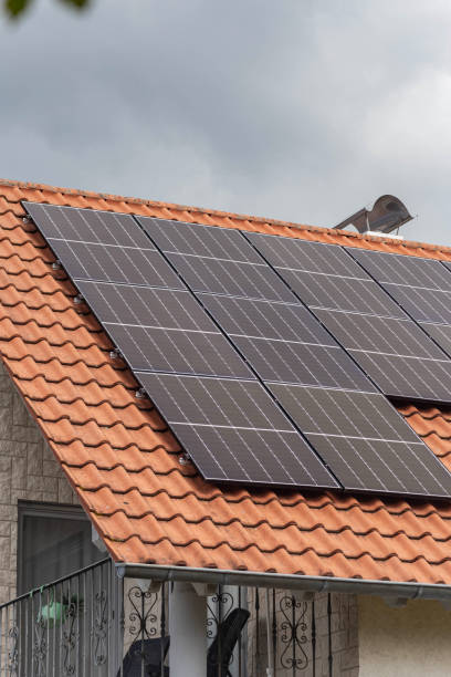 istock new building with solar panel on rooftop and garden green tree bush with cloudy sky weather 1704249985