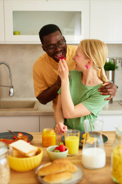 istock Multiracial couple enjoying breakfast together at home 1704253183