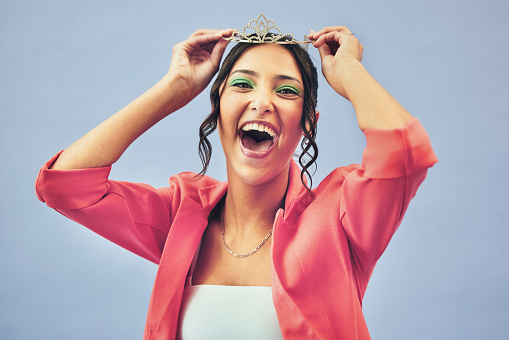 Fashion, excited and portrait of woman with crown in studio for glamour, luxury and winning prize. Beauty, wow and person with tiara for princess pageant, winner and cosmetics on purple background