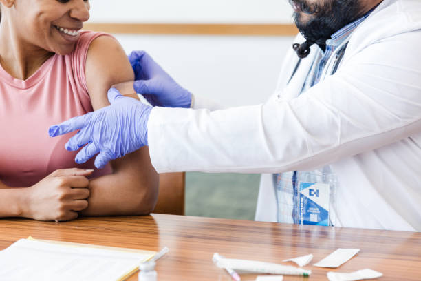 istock Female patient smiles proudly after getting her flu shot 1704271204