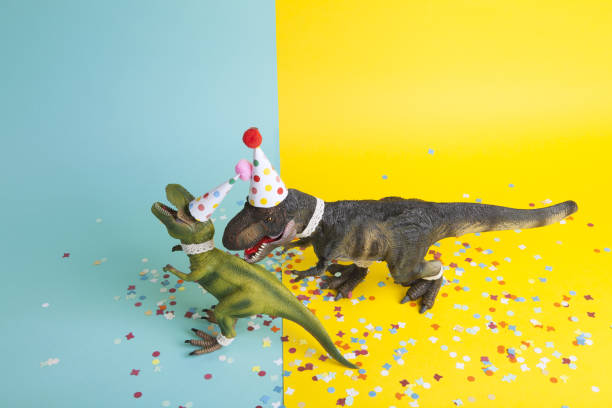 istock a pair of dinosaurs celebrating on a confetti carpet 1704271815