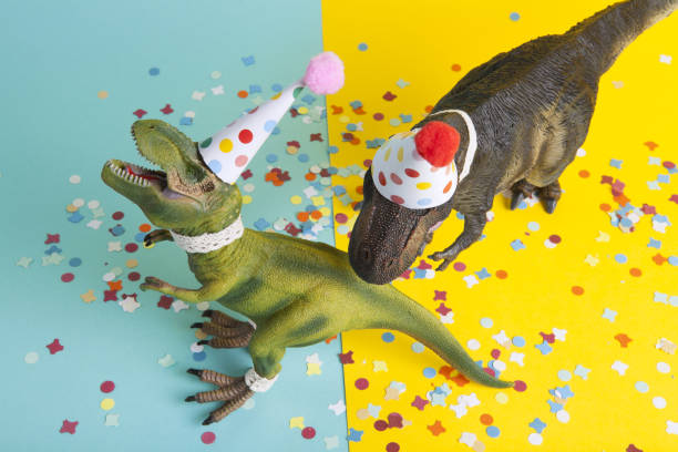 istock a pair of dinosaurs celebrating on a confetti carpet 1704272327
