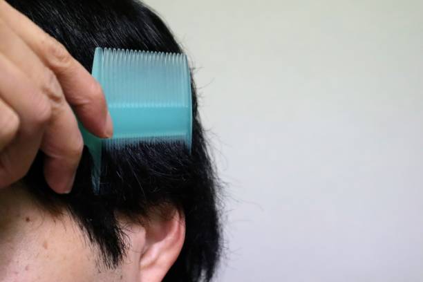 istock Japanese man combing his hair 1704276161