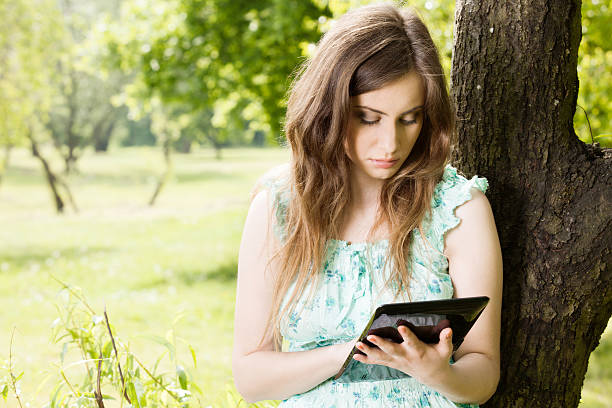 istock Young woman looking at her tablet 170428554