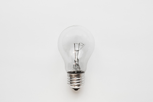 incandescent lamp on a white background. Energy and abandonment of traditional lighting sources