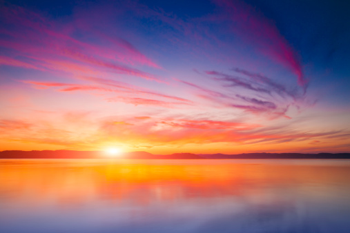 Dramatic sky of a mountain lake at dawn. Lake Mashu in Hokkaido, Japan.