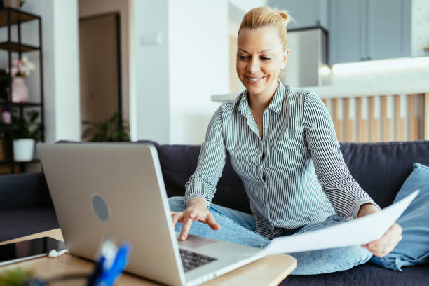 istock Mature entrepreneur working from home on laptop, anaylzing documents and doing paperwork 1704292764