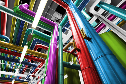 Multicolored pipes, tubes, machinery at a thermal power plant.