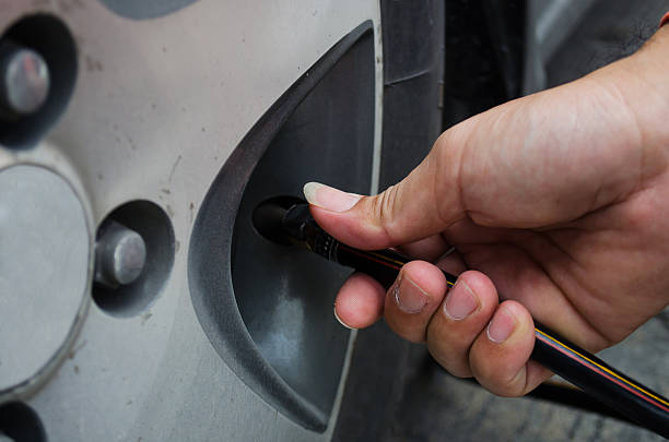 istock refilling air into a car tyre 170431177