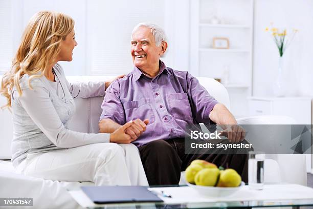 Home Caregiver Sitting N The Sofa With An Elderly Man Stock Photo - Download Image Now