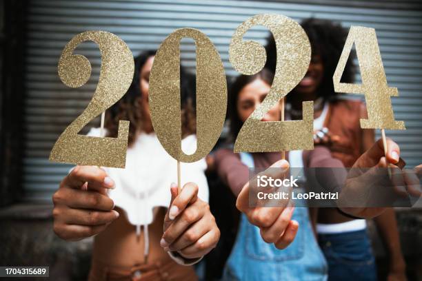 Group Of Friends Celebrating 2024 New Year Stock Photo - Download Image Now - New Year's Eve, 2024, Party - Social Event