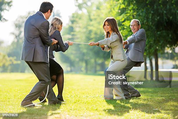 Businesspeople Playing Tug Of War Outdoors Stock Photo - Download Image Now - Tug-of-war, 30-39 Years, Achievement