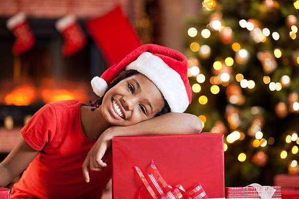 istock Cute girl leaning on Christmas present. 170431924