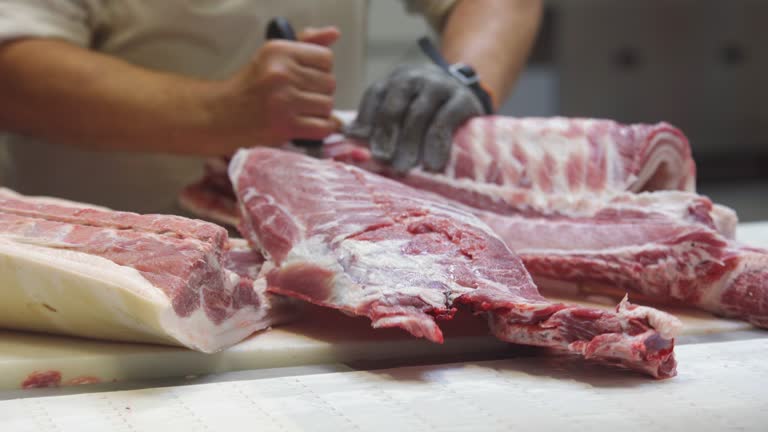 In the meat shop, the butcher separates the meat from the carcass of the animal