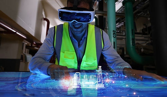 Engineer wearing VR gear to visualize projects in the manufacturing factory on the control  panel board