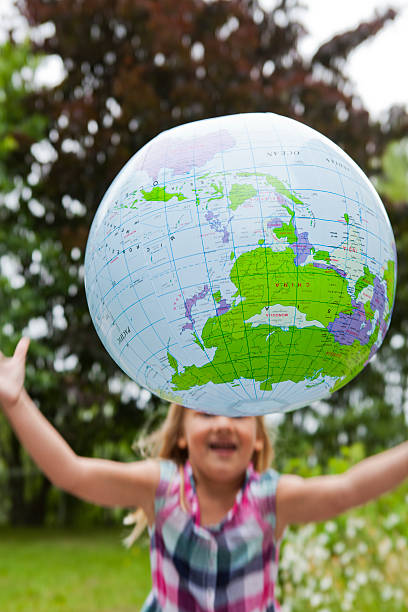 istock Girl throwing an earth globe 170433501