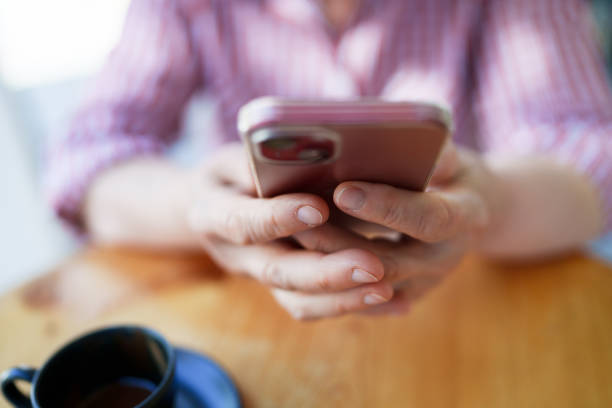 istock Retired senior woman using mobile phone in coffee shop. 1704336504