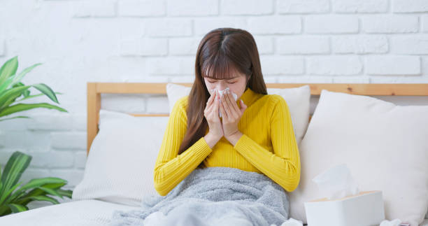 istock woman sick and sneezing 1704337042