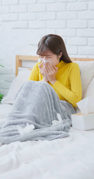 istock woman sick and sneezing 1704337064
