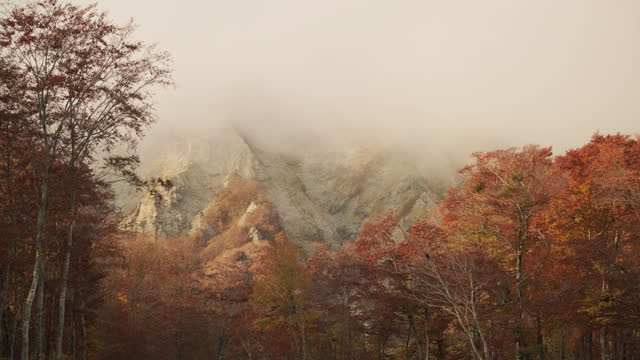 Dramatic landscape of clouds covering a snow mountain in autumn or fall, Mt.Daisen in Tottori Prefecture in Japan, Nature or travel