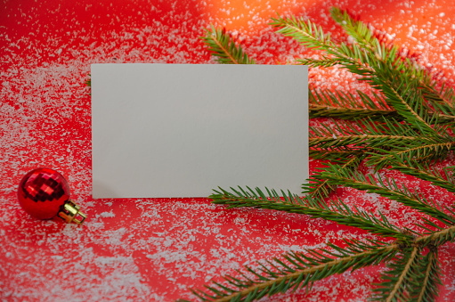 Christmas composition on a red background. Fir branches, red decorations, copy space. High quality photo