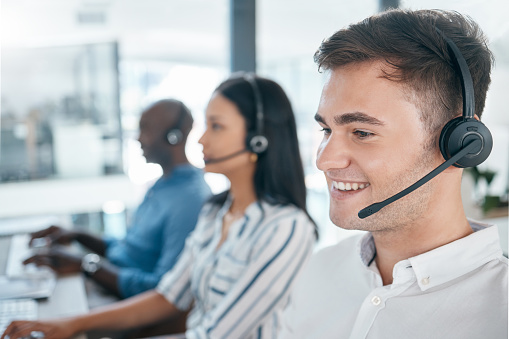 Call center, customer service and happy consultant team at crm or telemarketing office. Man and woman agent with diversity at pc for sales, contact us and online support or advice at help desk