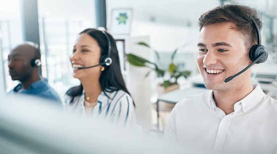 Call center, customer service and happy team for support, crm and telemarketing in office. Men and woman consultant at pc with a smile for sales target, contact us and online advice with teamwork