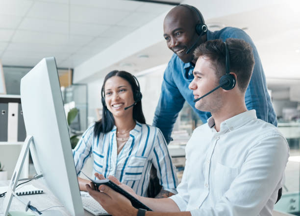 istock Business, manager help employees and call center for customer support, telemarketing or explain new system. Corporate training, black man or assist consultants with process, talking or client service 1704368741