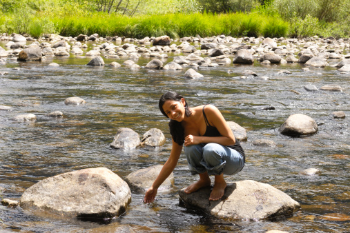 Pretty young latina woman and mountain river.