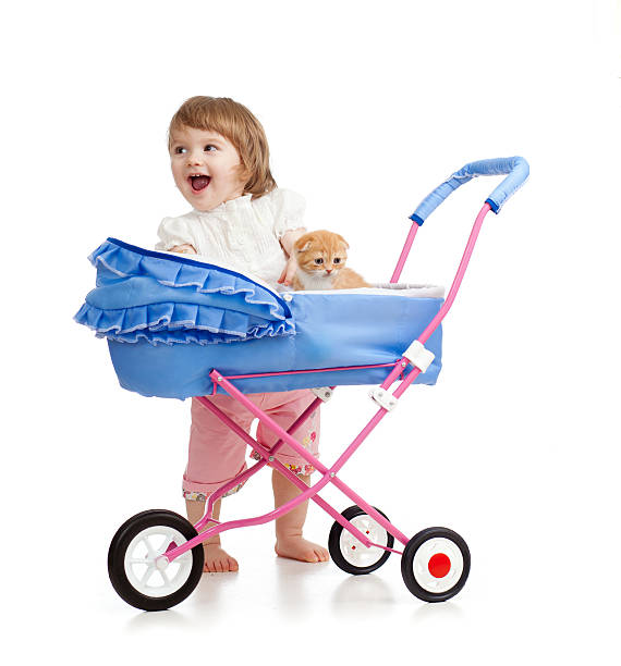 istock happy child girl playing with kitten 170441413