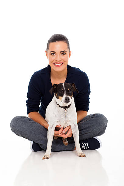 istock young woman sitting with her dog 170442487