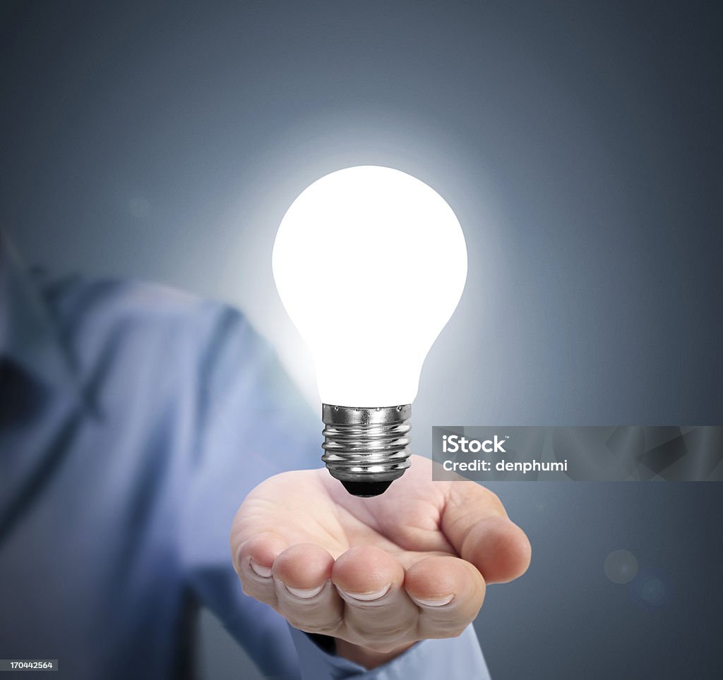 light bulb in hand Breaking New Ground Stock Photo