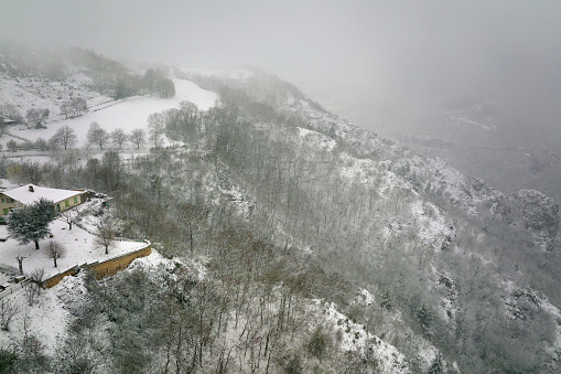 Traditional mountain remote cabins and houses in winter highlands.