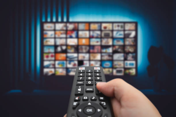 istock Man watching TV with remote control in hand. 1704449769