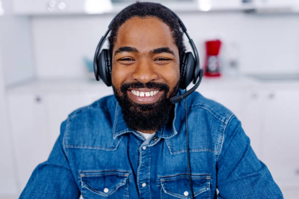istock African American man wearing a headset and cheerfully smiling 1704475071