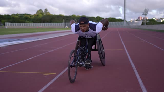 Athlete in wheelchair training on the running track