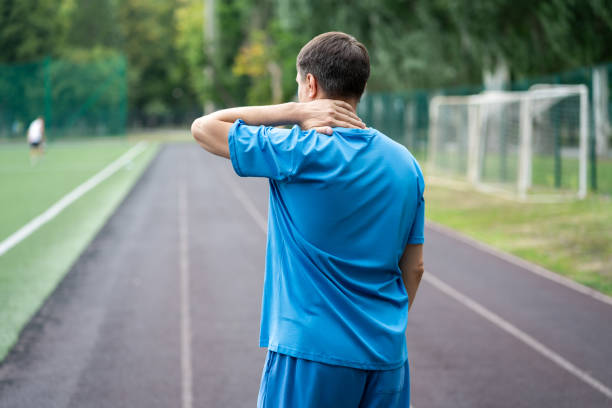 istock Neck pain, athletic man with backache on a running track after workout 1704479019