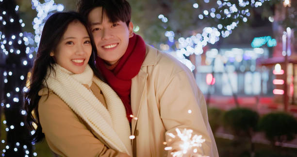 istock couple play sparkler together 1704490465